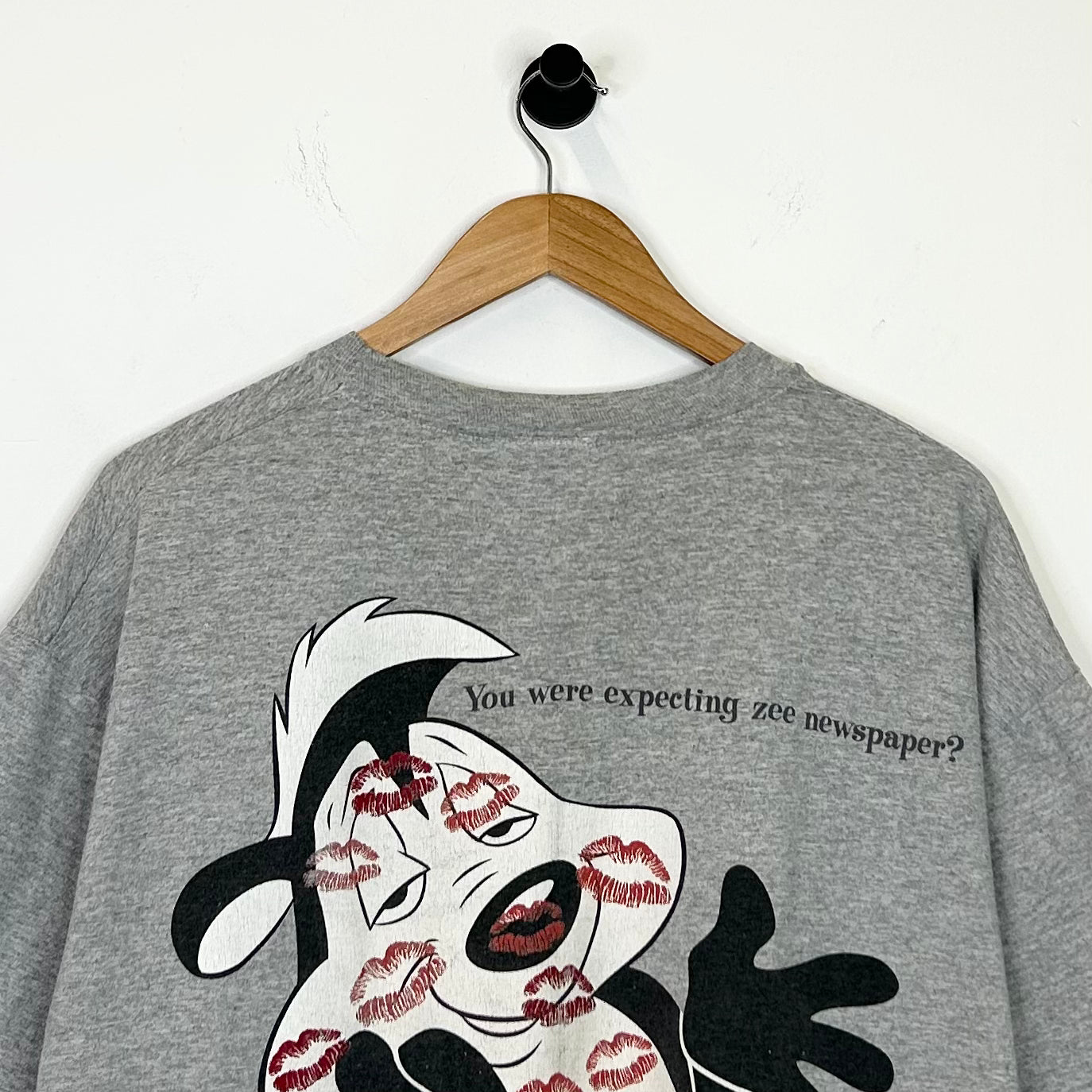 WHATS BLACK WHITE AND RED ALL OVER? TEE