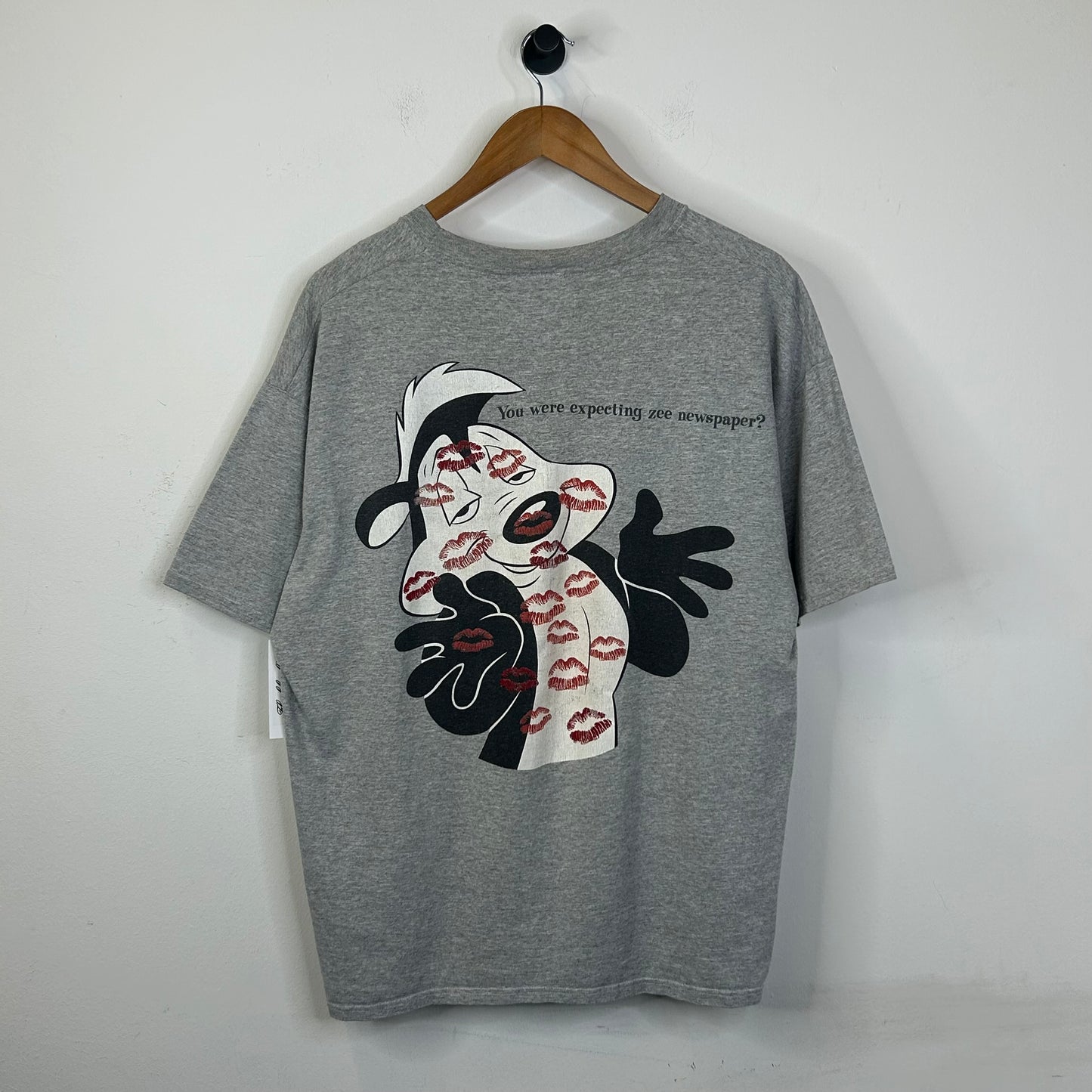 WHATS BLACK WHITE AND RED ALL OVER? TEE