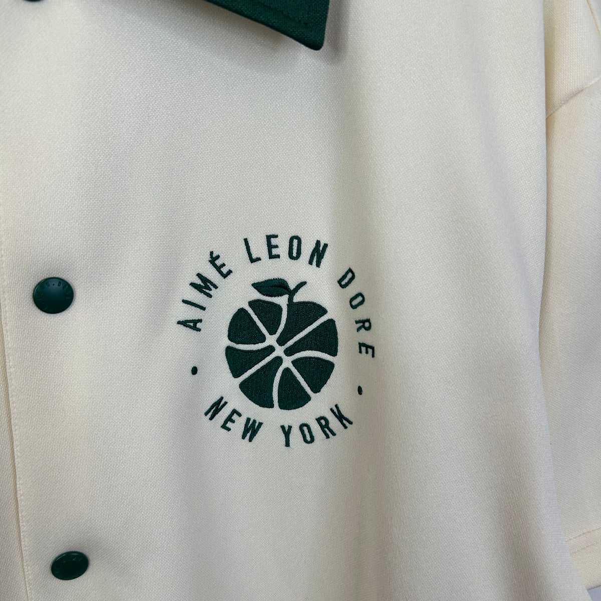 AIME LEON DORE X NEW BALANCE COLLARED CREAM TEE