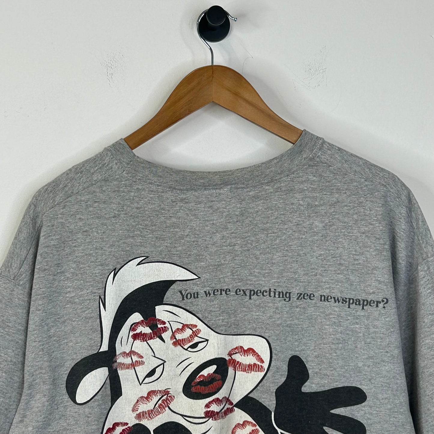 WHATS BLACK WHITE AND RED ALL OVER? TEE