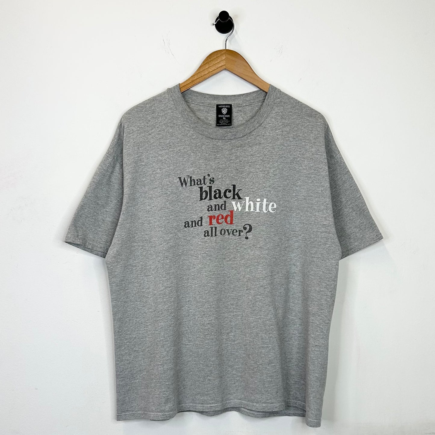 WHATS BLACK WHITE AND RED ALL OVER? TEE