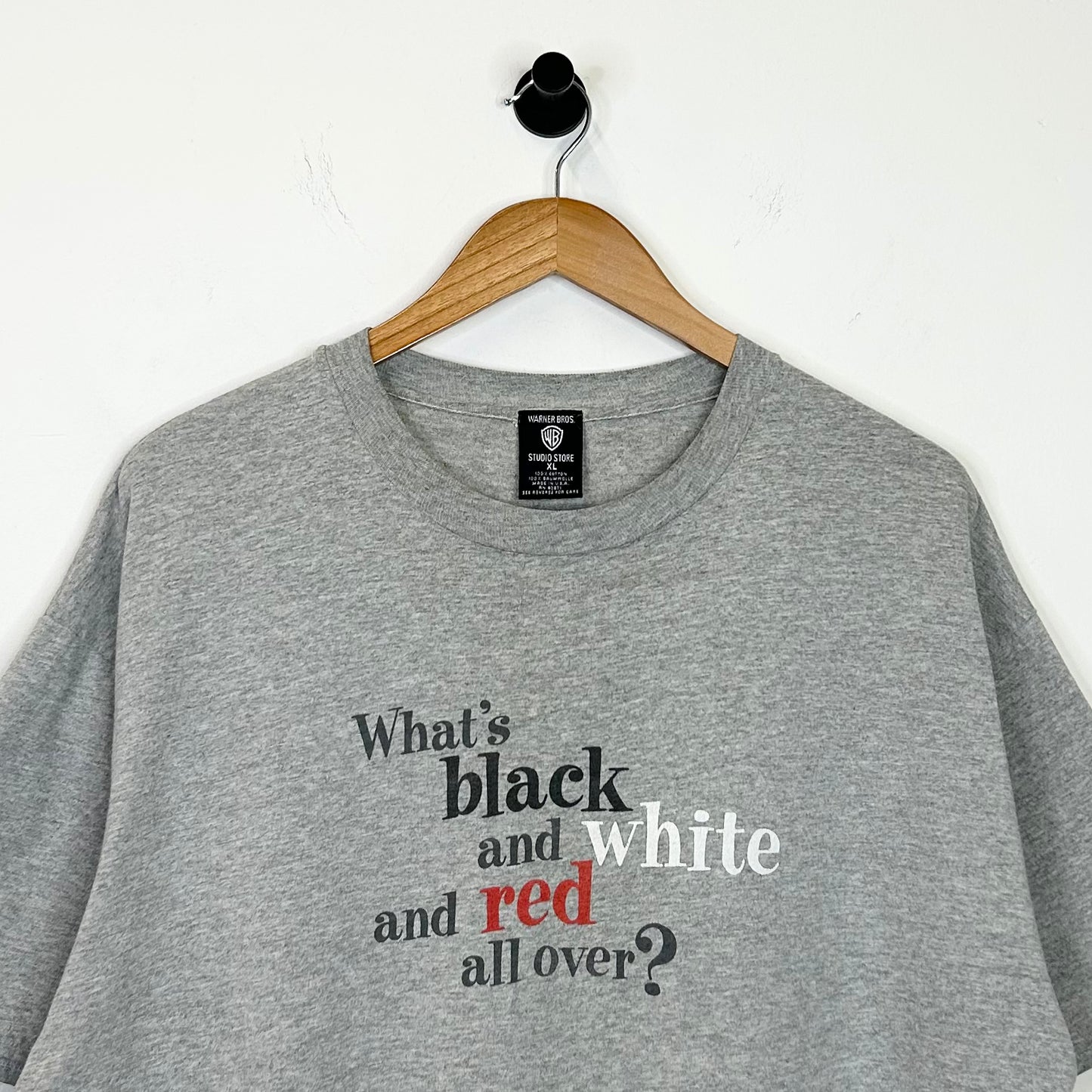WHATS BLACK WHITE AND RED ALL OVER? TEE