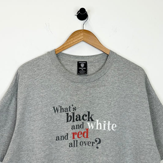 WHATS BLACK WHITE AND RED ALL OVER? TEE