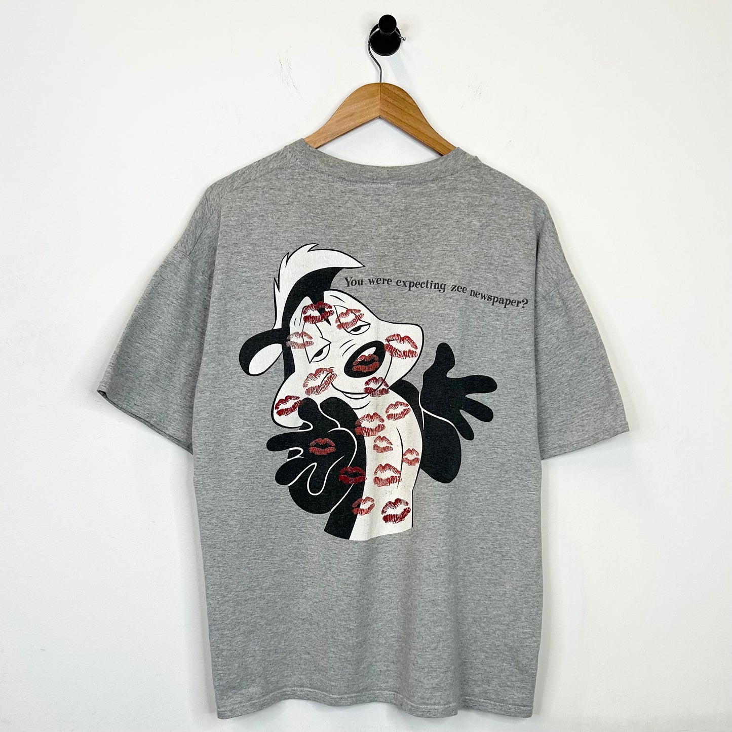 WHATS BLACK WHITE AND RED ALL OVER? TEE